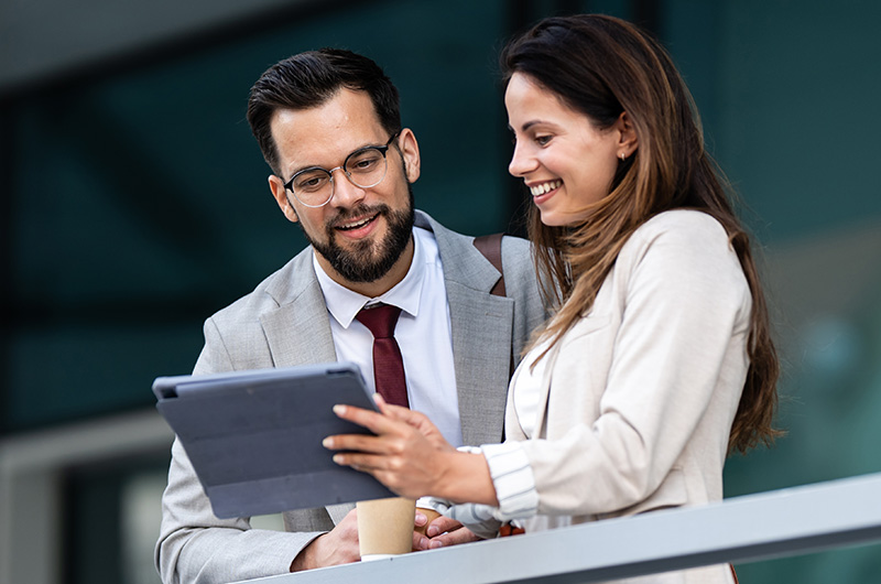 Take Control of Software, SaaS, AI, and Cloud Costs. Two businesswomen working on a tablet
