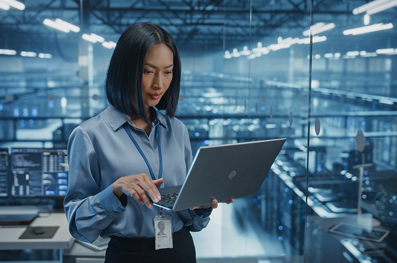 Get the Full Value From Your Flexera One Investment. Woman holding a tablet in a data centre