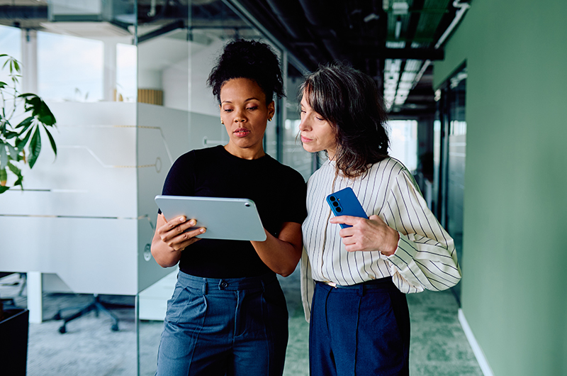 Take Control of Software, SaaS, AI, and Cloud Costs. Two businesswomen working on a tablet