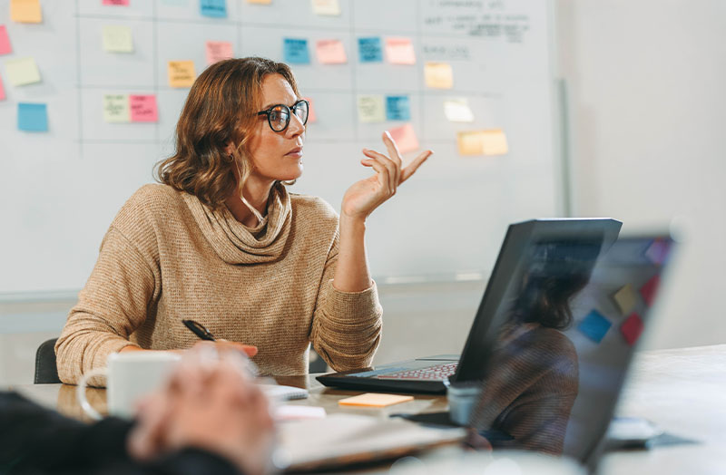 Image of woman pointing at a screen