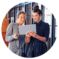 Two woman collaborating looking at tablet device