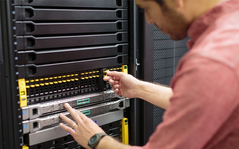 close-up of IT technician working in server room