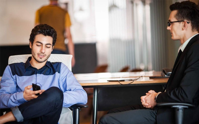 Two business men working on mobile device using wi-fi