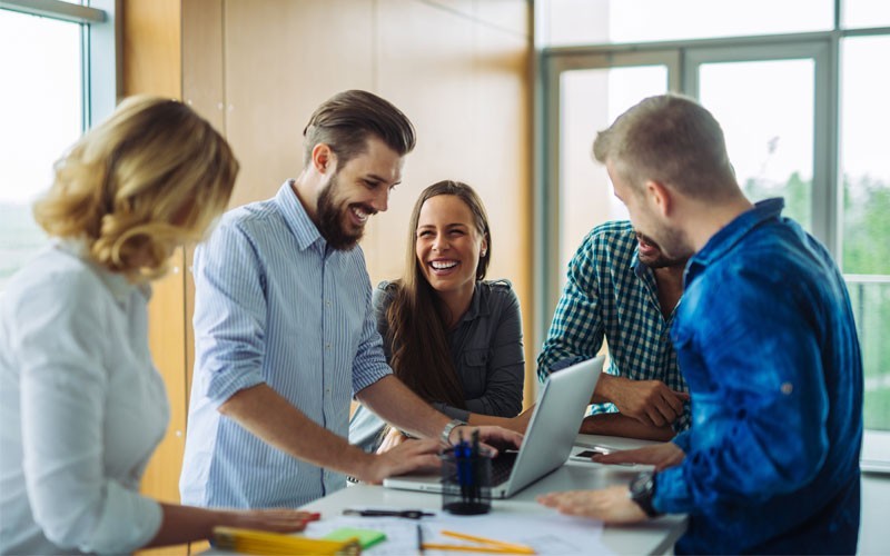 Group of employees on laptop