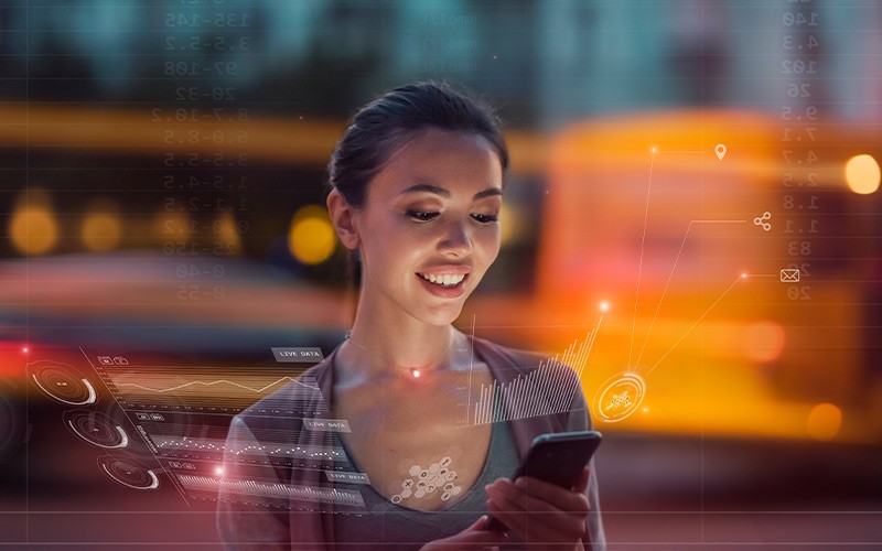 Woman smiling while working on a smartphone